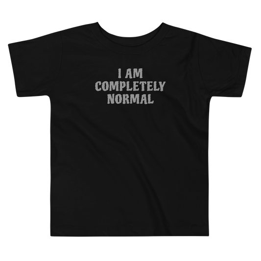 "I am completely normal" printed on a black toddler short sleeve tee laying on a flat surface