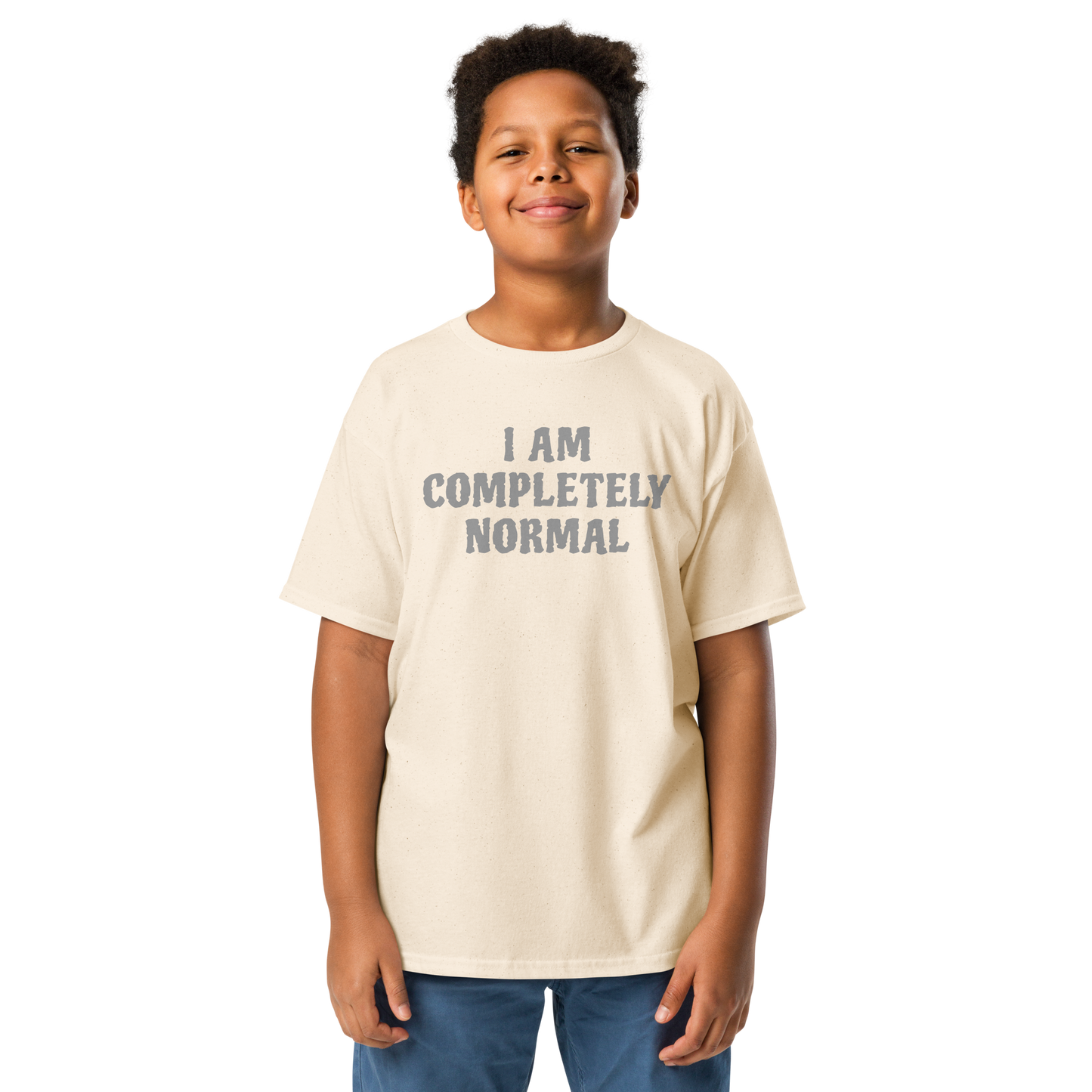 "I am completely normal" printed on a natural youth classic tee worn by a male
