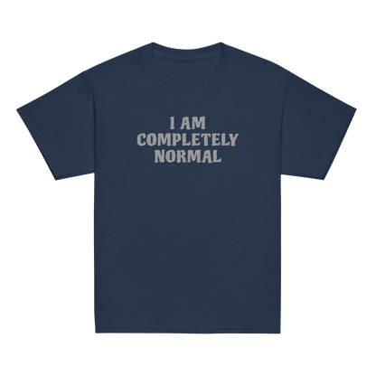 "I am completely normal" printed on a navy youth classic tee laying on a flat surface