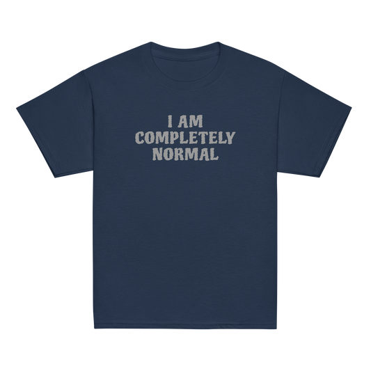 "I am completely normal" printed on a navy youth classic tee laying on a flat surface