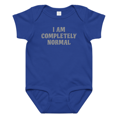 "I am completely normal" printed on a royal baby jersey bodysuit laying on a flat surface amongst other clothes