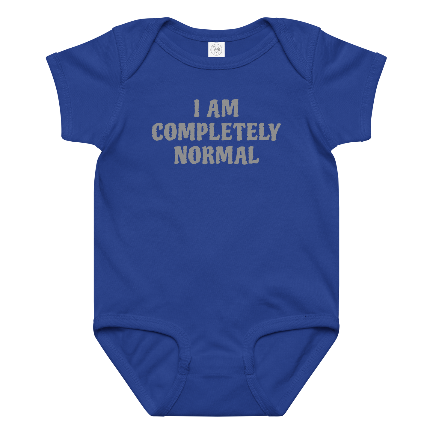 "I am completely normal" printed on a royal baby jersey bodysuit laying on a flat surface amongst other clothes