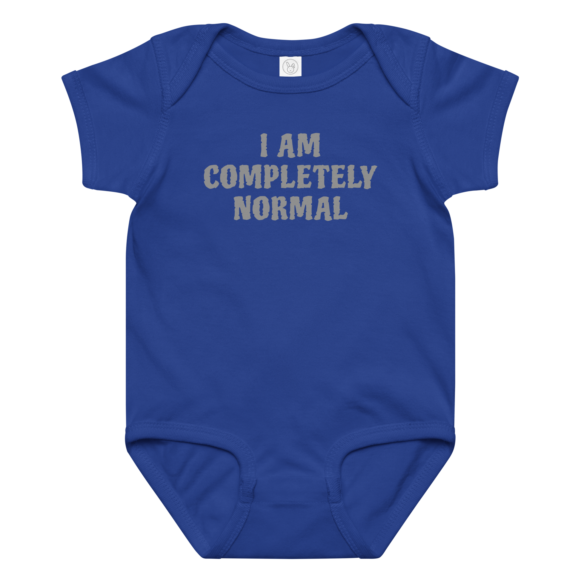 "I am completely normal" printed on a royal baby jersey bodysuit laying on a flat surface amongst other clothes