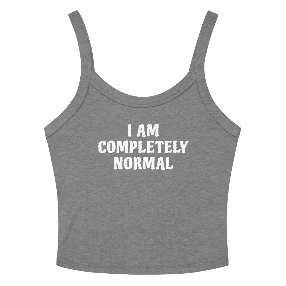 "I am completely normal" printed on a athletic heather women's micro-rib tanktop laying on a flat surface amongst sunglasses and shorts