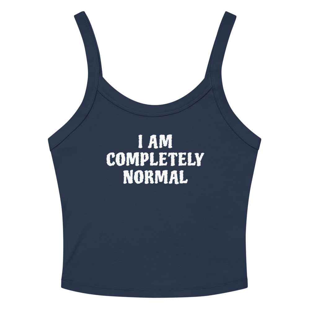 "I am completely normal" printed on a solid navy blend women's micro-rib tanktop laying on a flat surface amongst sunglasses and shorts