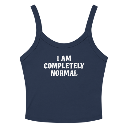 "I am completely normal" printed on a solid navy blend women's micro-rib tanktop laying on a flat surface amongst sunglasses and shorts
