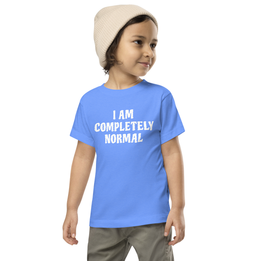 "I am completely normal" printed on a heather columbia blue toddler short sleeve tee worn by a male wearing a cap