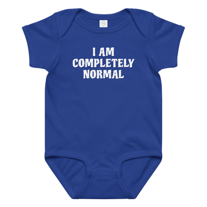 "I am completely normal" printed on a royal baby jersey bodysuit laying on a flat surface amongst other clothes