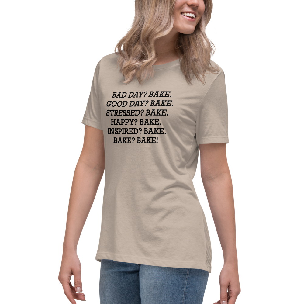 "Bad Day? Bake. Good Day? Bake. Stressed? Bake. Happy? Bake. Inspired? Bake. Bake? Bake!" printed on a heather stone women's relaxed t-shirt worn by a female