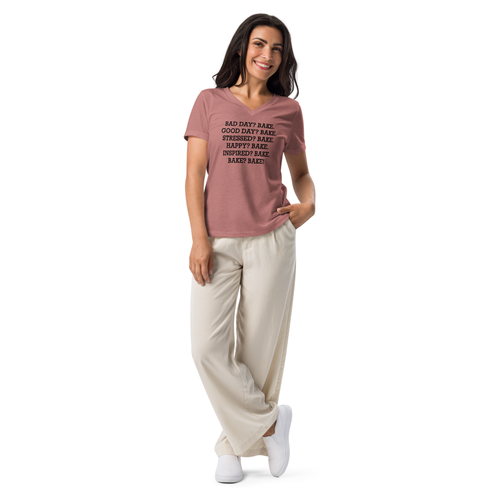 "Bad Day? Bake. Good Day? Bake. Stressed? Bake. Happy? Bake. Inspired? Bake. Bake? Bake!" printed on a heather mauve women's relaxed v-neck t-shirt worn by a female