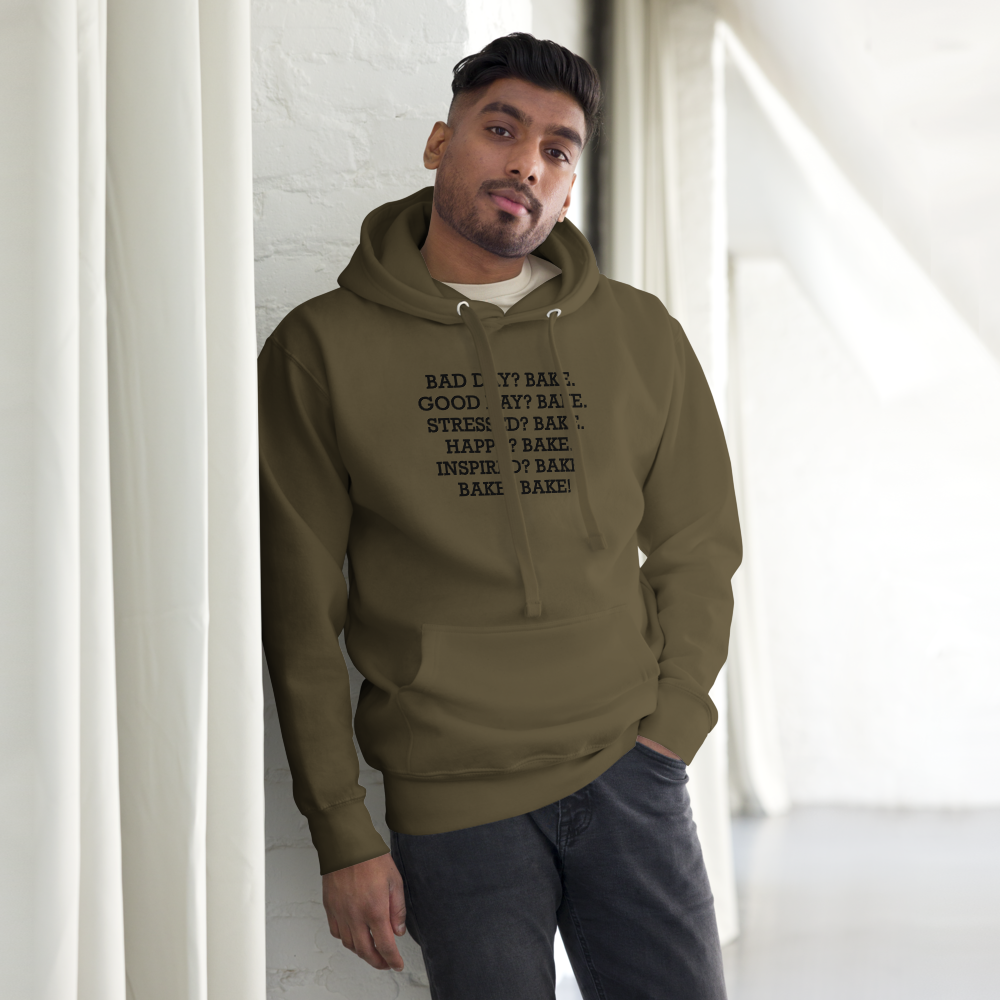 "Bad Day? Bake. Good Day? Bake. Stressed? Bake. Happy? Bake. Inspired? Bake. Bake? Bake!" printed on a military green unisex hoodie worn by a male