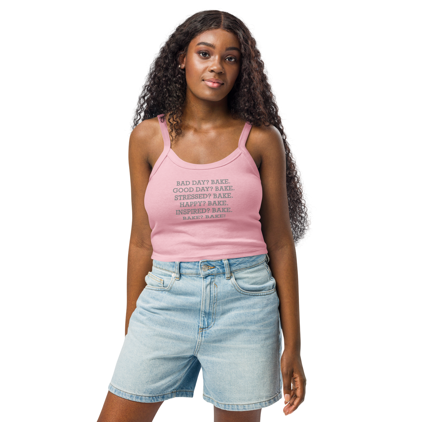 "Bad Day? Bake. Good Day? Bake. Stressed? Bake. Happy? Bake. Inspired? Bake. Bake? Bake!" printed on a solid pink blend women's micro-rib tanktop worn by a female