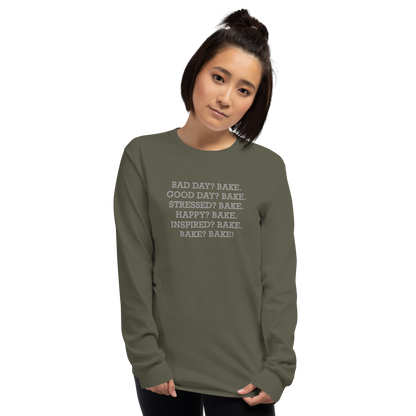 "Bad Day? Bake. Good Day? Bake. Stressed? Bake. Happy? Bake. Inspired? Bake. Bake? Bake!" printed on a military green men's long sleeve shirt worn by a female