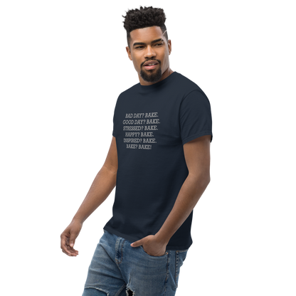 "Bad Day? Bake. Good Day? Bake. Stressed? Bake. Happy? Bake. Inspired? Bake. Bake? Bake!" printed on a navy unisex classic tee worn by a male