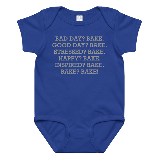 "Bad Day? Bake. Good Day? Bake. Stressed? Bake. Happy? Bake. Inspired? Bake. Bake? Bake!" printed on a royal baby jersey bodysuit laying on a flat surface amongst other clothes