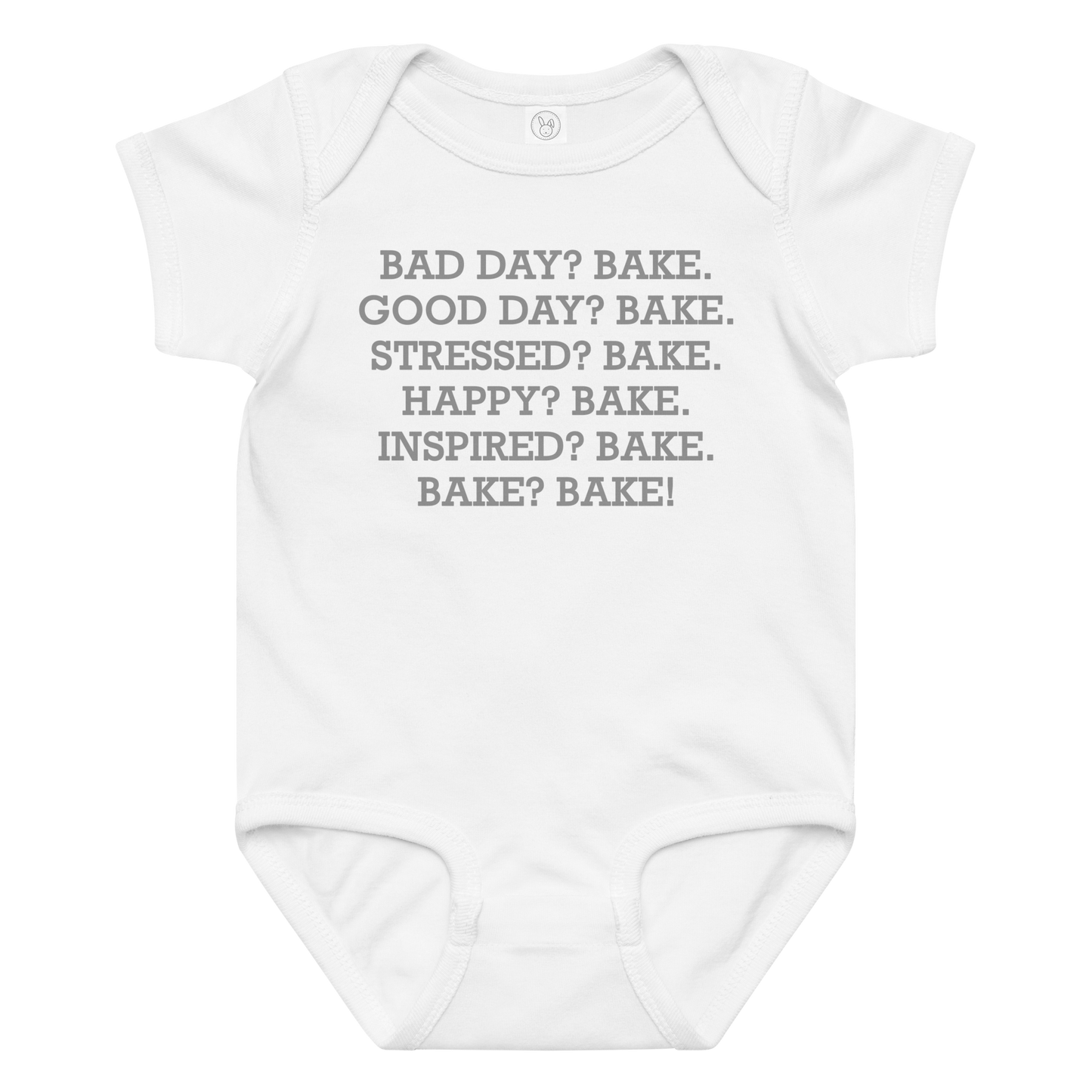 "Bad Day? Bake. Good Day? Bake. Stressed? Bake. Happy? Bake. Inspired? Bake. Bake? Bake!" printed on a white baby jersey bodysuit laying on a flat surface amongst other clothes