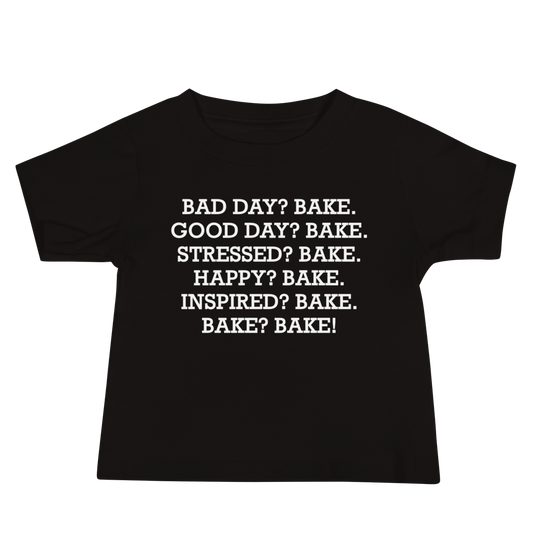 "Bad Day? Bake. Good Day? Bake. Stressed? Bake. Happy? Bake. Inspired? Bake. Bake? Bake!" printed on a black baby jersey short sleeve tee laying on a flat surface