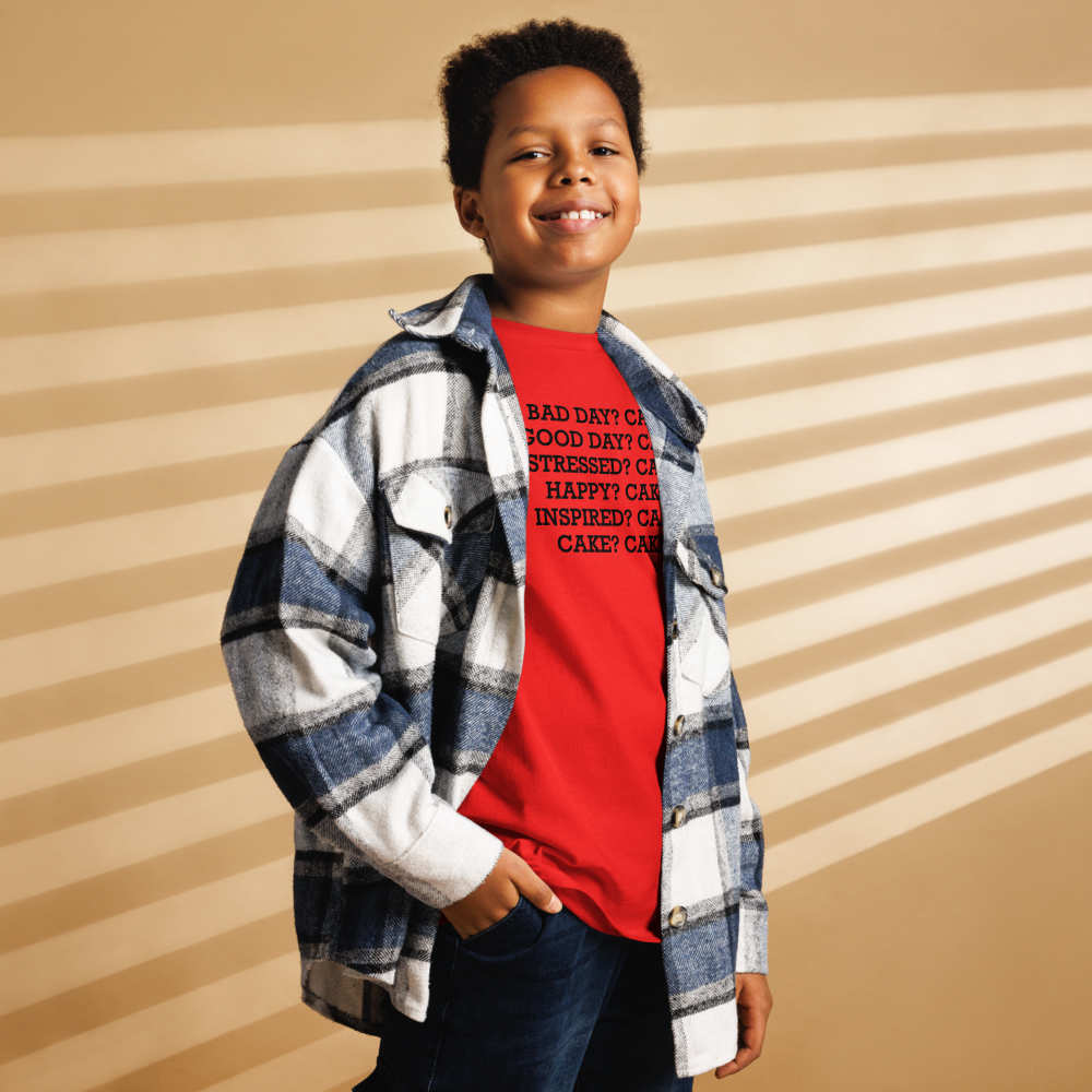 "Bad Day? Cake. Good Day? Cake. Stressed? Cake. Happy? Cake. Inspired? Cake. Cake? Cake!" printed on a red youth classic tee worn by a male also wearing a jacket