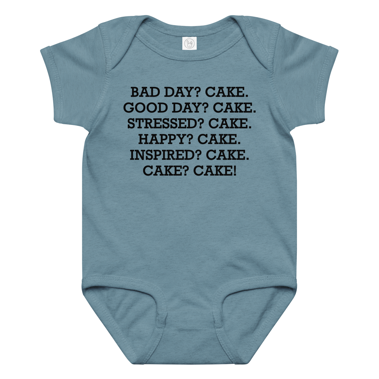 "Bad Day? Cake. Good Day? Cake. Stressed? Cake. Happy? Cake. Inspired? Cake. Cake? Cake!" printed on a vintage indigo baby jersey bodysuit laying on a flat surface amongst other clothes