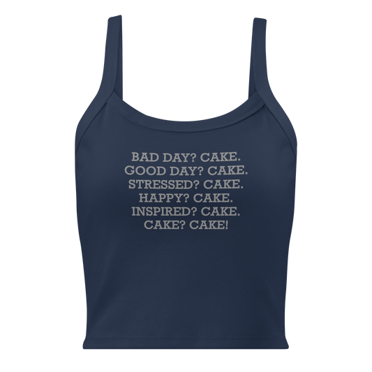 "Bad Day? Cake. Good Day? Cake. Stressed? Cake. Happy? Cake. Inspired? Cake. Cake? Cake!" printed on a solid navy blend women's micro-rib tanktop laying on a flat surface
