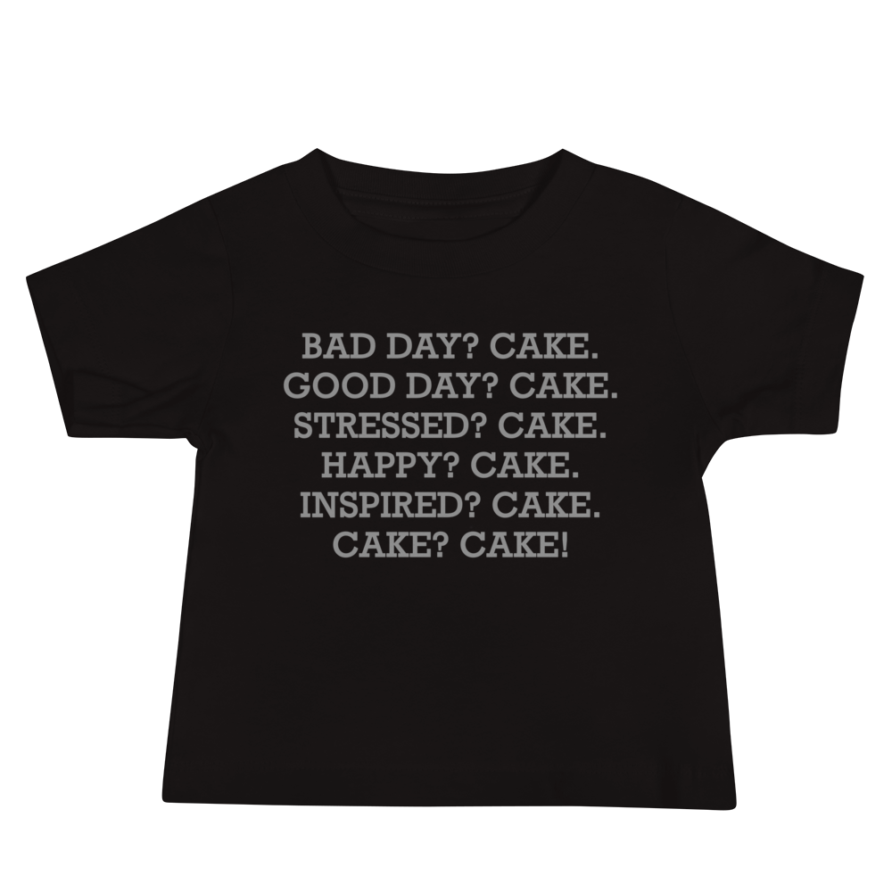 "Bad Day? Cake. Good Day? Cake. Stressed? Cake. Happy? Cake. Inspired? Cake. Cake? Cake!" printed on a black baby jersey short sleeve tee laying on a flat surface