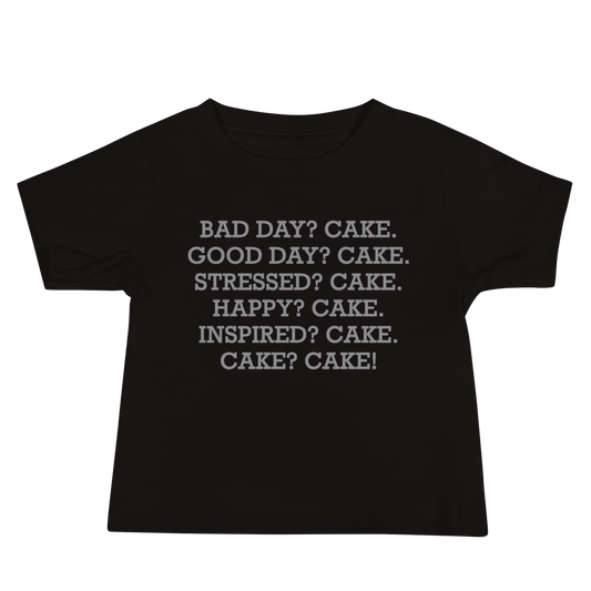 "Bad Day? Cake. Good Day? Cake. Stressed? Cake. Happy? Cake. Inspired? Cake. Cake? Cake!" printed on a black baby jersey short sleeve tee laying on a flat surface