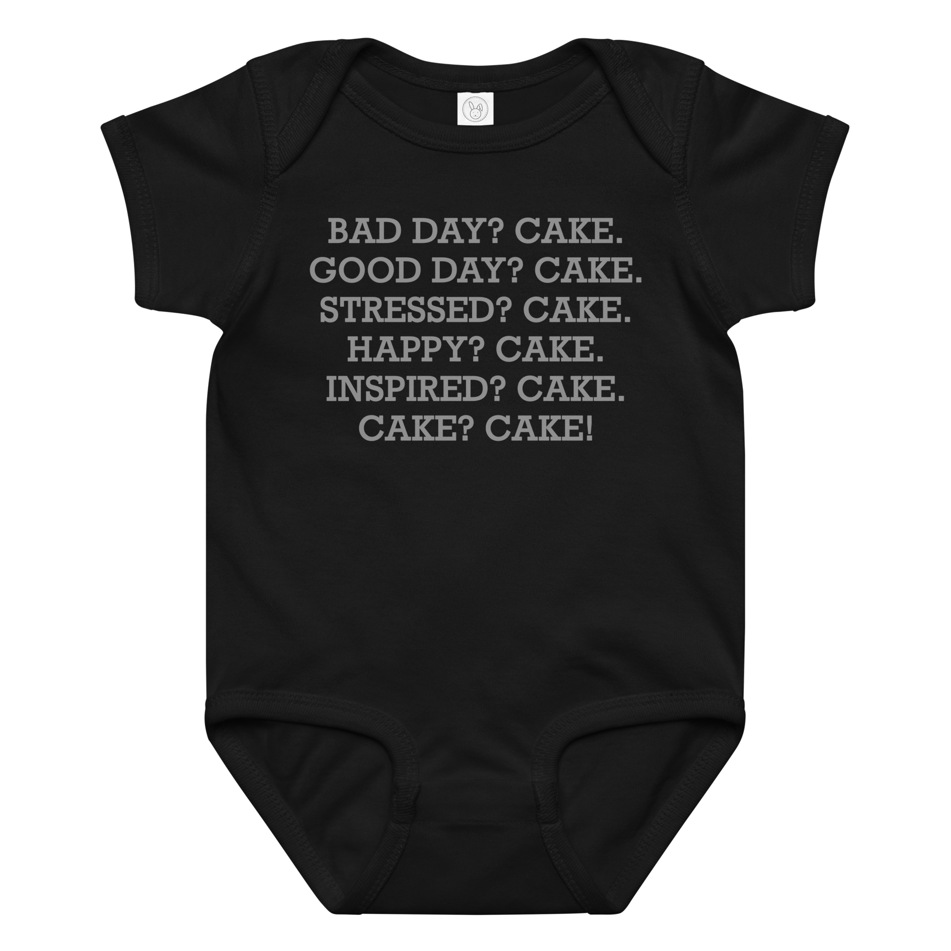 "Bad Day? Cake. Good Day? Cake. Stressed? Cake. Happy? Cake. Inspired? Cake. Cake? Cake!" printed on a black baby jersey bodysuit laying on a flat surface amongst other clothes