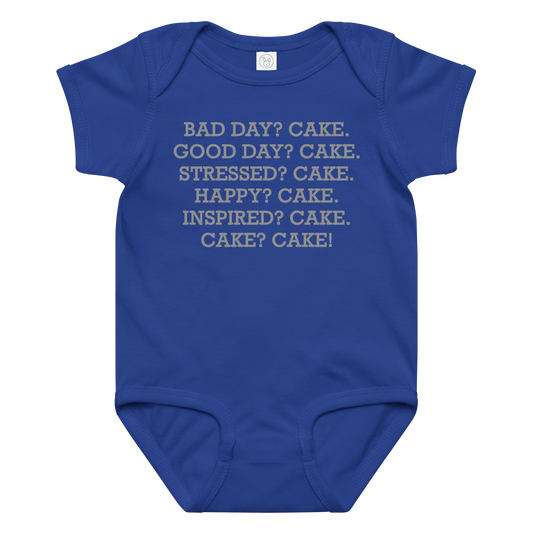 "Bad Day? Cake. Good Day? Cake. Stressed? Cake. Happy? Cake. Inspired? Cake. Cake? Cake!" printed on a royal baby jersey bodysuit laying on a flat surface amongst other clothes