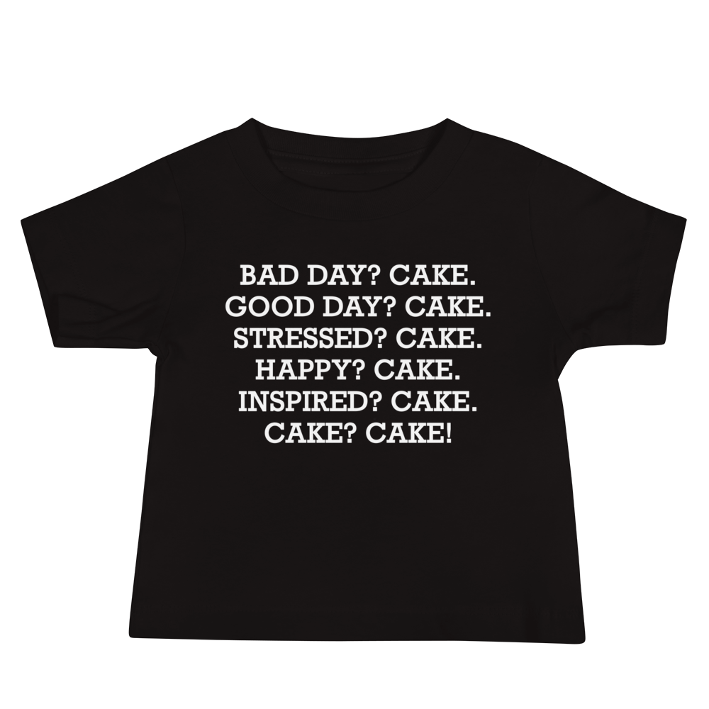 "Bad Day? Cake. Good Day? Cake. Stressed? Cake. Happy? Cake. Inspired? Cake. Cake? Cake!" printed on a black baby jersey short sleeve tee laying on a flat surface