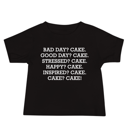 "Bad Day? Cake. Good Day? Cake. Stressed? Cake. Happy? Cake. Inspired? Cake. Cake? Cake!" printed on a black baby jersey short sleeve tee laying on a flat surface