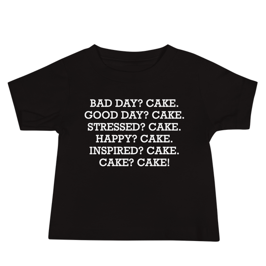 "Bad Day? Cake. Good Day? Cake. Stressed? Cake. Happy? Cake. Inspired? Cake. Cake? Cake!" printed on a black baby jersey short sleeve tee laying on a flat surface