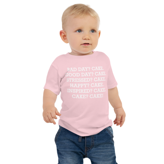 "Bad Day? Cake. Good Day? Cake. Stressed? Cake. Happy? Cake. Inspired? Cake. Cake? Cake!" printed on a pink baby jersey short sleeve tee worn by a male