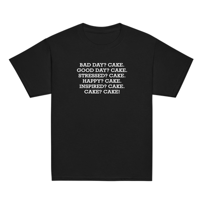 "Bad Day? Cake. Good Day? Cake. Stressed? Cake. Happy? Cake. Inspired? Cake. Cake? Cake!" printed on a black youth classic tee laying on a flat surface