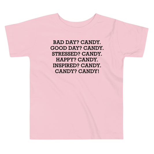 "Bad Day? Candy. Good Day? Candy. Stressed? Candy. Happy? Candy. Inspired? Candy. Candy? Candy!" printed on a pink toddler short sleeve tee laying on a flat surface