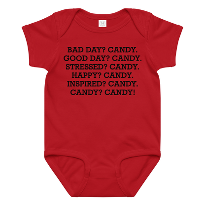 "Bad Day? Candy. Good Day? Candy. Stressed? Candy. Happy? Candy. Inspired? Candy. Candy? Candy!" printed on a red baby jersey bodysuit laying on a flat surface amongst other clothes