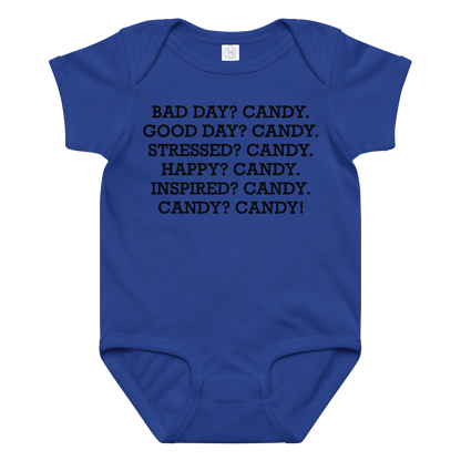 "Bad Day? Candy. Good Day? Candy. Stressed? Candy. Happy? Candy. Inspired? Candy. Candy? Candy!" printed on a royal baby jersey bodysuit laying on a flat surface amongst other clothes