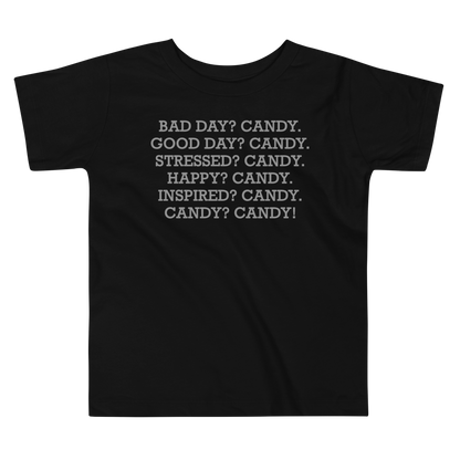 "Bad Day? Candy. Good Day? Candy. Stressed? Candy. Happy? Candy. Inspired? Candy. Candy? Candy!" printed on a black toddler short sleeve tee laying on a flat surface