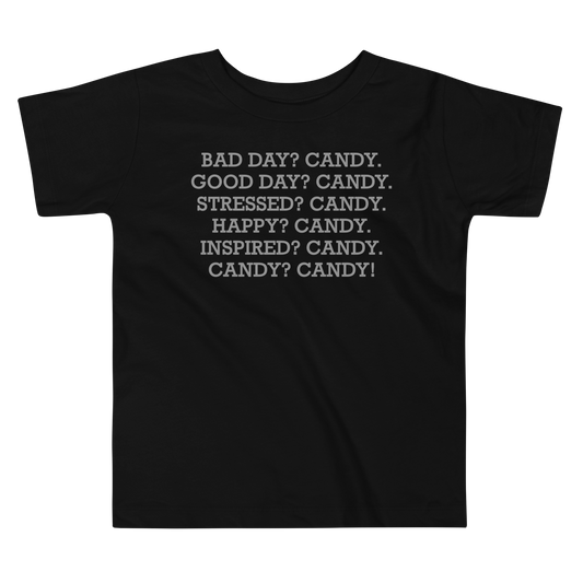 "Bad Day? Candy. Good Day? Candy. Stressed? Candy. Happy? Candy. Inspired? Candy. Candy? Candy!" printed on a black toddler short sleeve tee laying on a flat surface