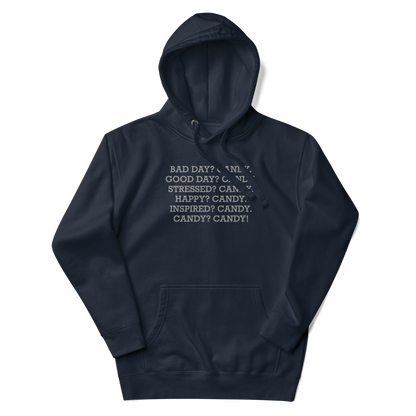 "Bad Day? Candy. Good Day? Candy. Stressed? Candy. Happy? Candy. Inspired? Candy. Candy? Candy!" printed on a navy blazer unisex hoodie laying on a flat surface with the hood up
