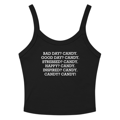 "Bad Day? Candy. Good Day? Candy. Stressed? Candy. Happy? Candy. Inspired? Candy. Candy? Candy!" printed on a solid black blend women's micro-rib tanktop laying on a flat surface amongst sunglasses and shorts