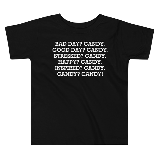 "Bad Day? Candy. Good Day? Candy. Stressed? Candy. Happy? Candy. Inspired? Candy. Candy? Candy!" printed on a black toddler short sleeve tee laying on a flat surface