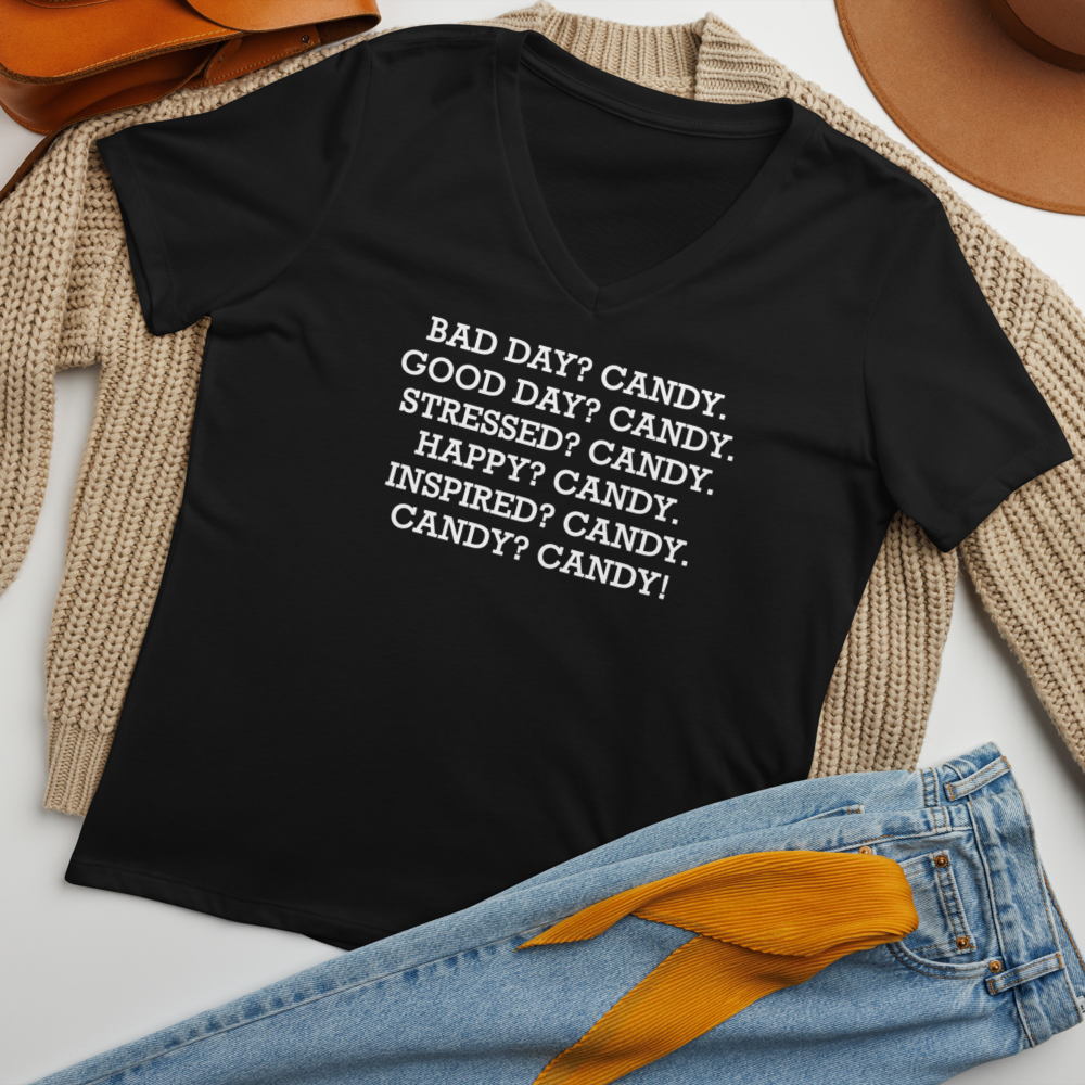 "Bad Day? Candy. Good Day? Candy. Stressed? Candy. Happy? Candy. Inspired? Candy. Candy? Candy!" printed on a solid black blend women's relaxed v-neck t-shirt laying on a flat surface amongst other clothes