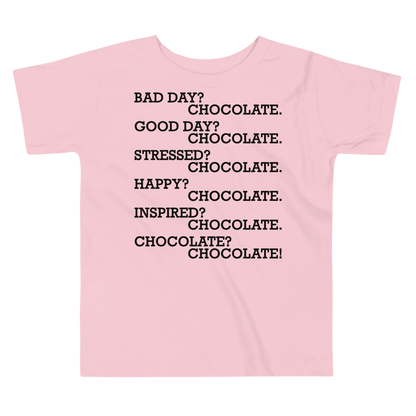 "Bad Day? Chocolate. Good Day? Chocolate. Stressed? Chocolate. Happy? Chocolate. Inspired? Chocolate. Chocolate? Chocolate!" printed on a pink toddler short sleeve tee laying on a flat surface