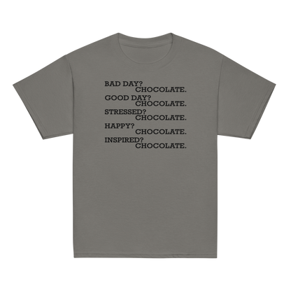 "Bad Day? Chocolate. Good Day? Chocolate. Stressed? Chocolate. Happy? Chocolate. Inspired? Chocolate. Chocolate? Chocolate!" printed on a charcoal youth classic tee laying on a flat surface