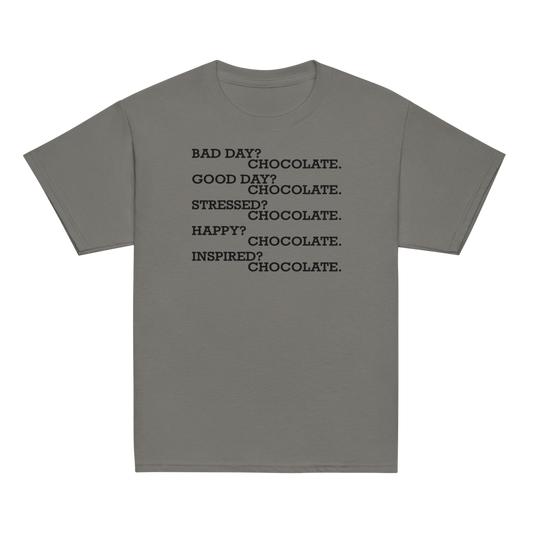 "Bad Day? Chocolate. Good Day? Chocolate. Stressed? Chocolate. Happy? Chocolate. Inspired? Chocolate. Chocolate? Chocolate!" printed on a charcoal youth classic tee laying on a flat surface