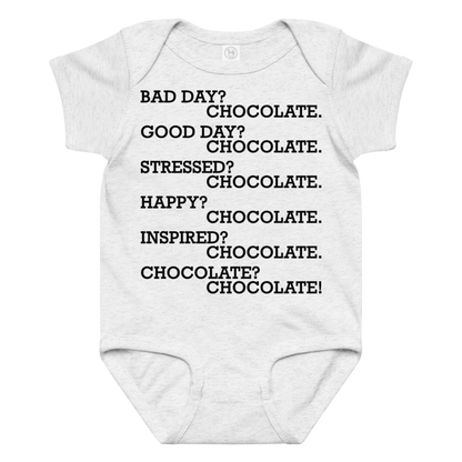 "Bad Day? Chocolate. Good Day? Chocolate. Stressed? Chocolate. Happy? Chocolate. Inspired? Chocolate. Chocolate? Chocolate!" printed on a ash baby jersey bodysuit laying on a flat surface amongst other clothes