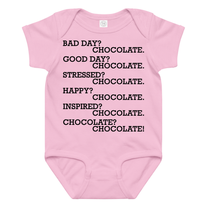 "Bad Day? Chocolate. Good Day? Chocolate. Stressed? Chocolate. Happy? Chocolate. Inspired? Chocolate. Chocolate? Chocolate!" printed on a pink baby jersey bodysuit laying on a flat surface amongst other clothes