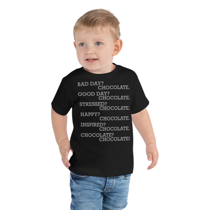 "Bad Day? Chocolate. Good Day? Chocolate. Stressed? Chocolate. Happy? Chocolate. Inspired? Chocolate. Chocolate? Chocolate!" printed on a black toddler short sleeve tee worn by a male