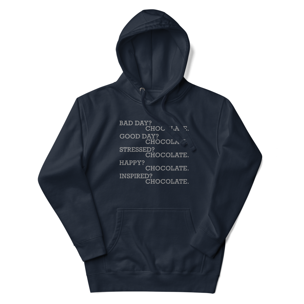 "Bad Day? Chocolate. Good Day? Chocolate. Stressed? Chocolate. Happy? Chocolate. Inspired? Chocolate. Chocolate? Chocolate!" printed on a navy blazer unisex hoodie laying on a flat surface with the hood up