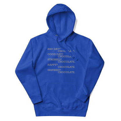 "Bad Day? Chocolate. Good Day? Chocolate. Stressed? Chocolate. Happy? Chocolate. Inspired? Chocolate. Chocolate? Chocolate!" printed on a team royal unisex hoodie laying on a flat surface with the hood up